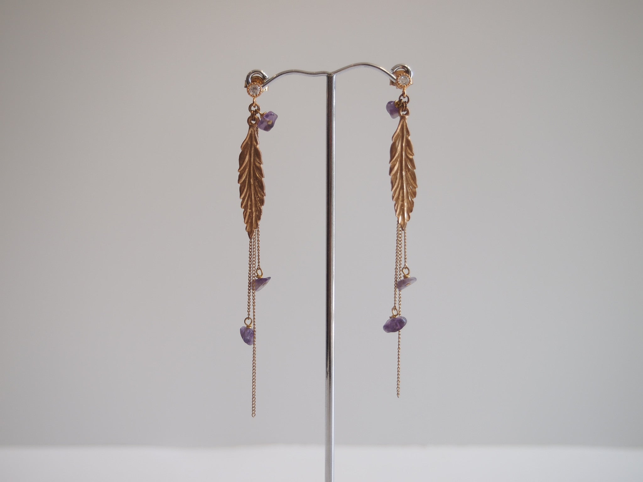 Handmade earrings with purple amethyst with gold-plated leaf design